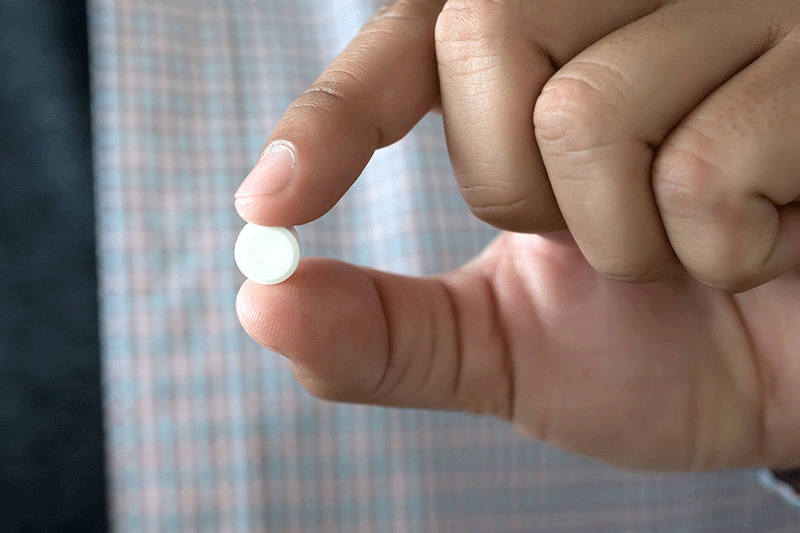 pill in fingertips