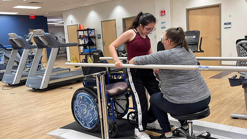 Bella Chambasis working to regain strength in her arms and legs with the help of physical therapist Jadean Hoff