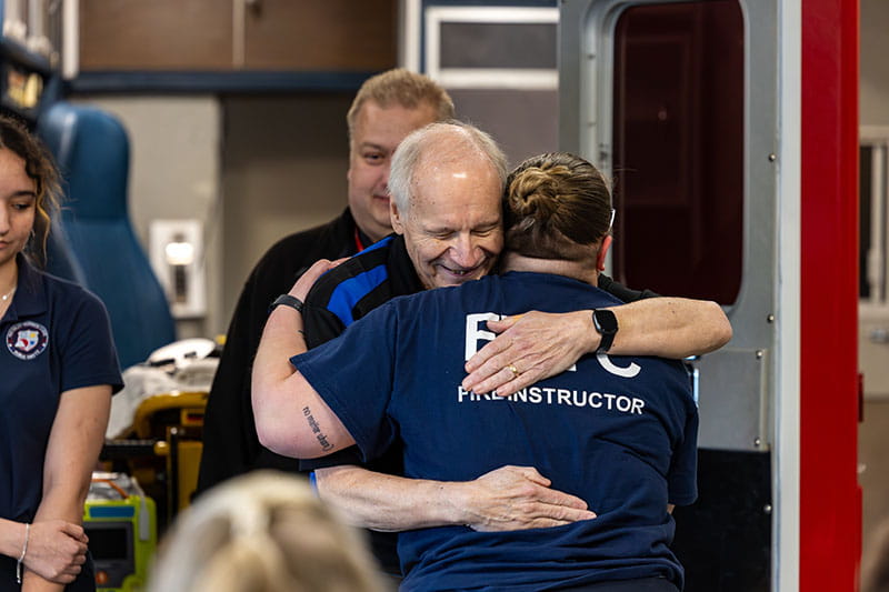 Students and instructors welcomed Karl with hugs, smiles and applause.