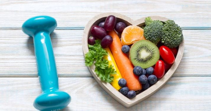 stock photo of five pound barbell with fruit in a heart-shaped bowl