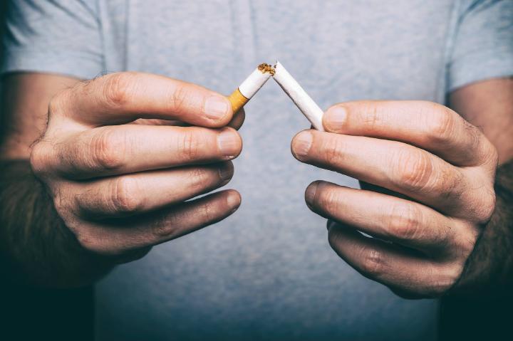 man breaking cigarette 