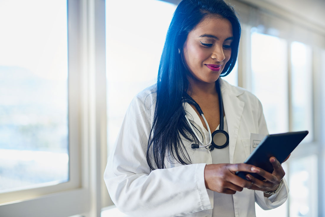 Doctor reading information on a tablet