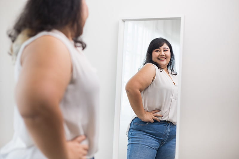 Girl looking in the mirror with a smile
