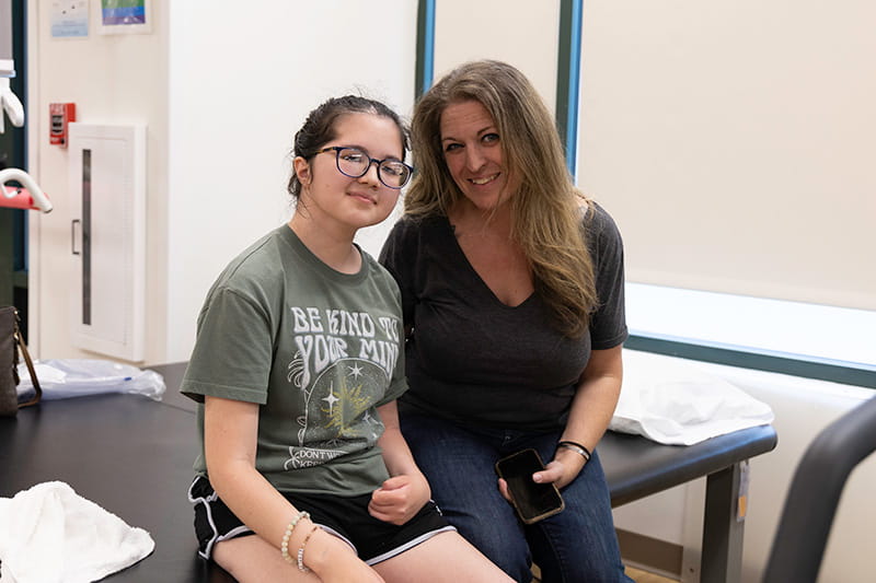 Deann Hurley sitting with her daughter, Bella Chambasis