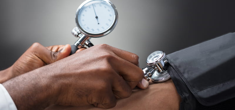 African-American doctor taking BP