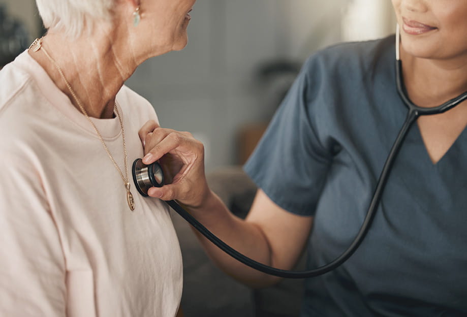 Provider using stethoscope on patient