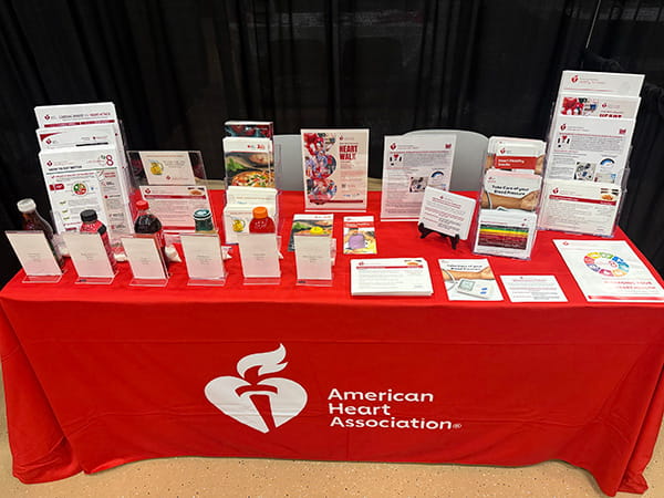 an American Heart Association table laid out with pamphlets and informational handouts