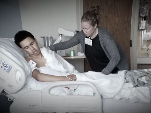 Dra laying in hospital bed after having a stroke